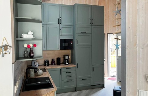 Norderteil House | 12 person family holiday home with sauna, whirlpool, two showers and toilets, wood-burning stove and canoe in 1st row to the lake with wonderful lake view in Otterndorf