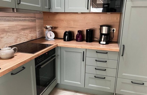 Norderteil House | 12 person family holiday home with sauna, whirlpool, two showers and toilets, wood-burning stove and canoe in 1st row to the lake with wonderful lake view in Otterndorf