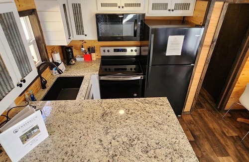 Mill Spring House | 2-story tiny home nestled on the creek, quick walk to pool and playground, private firepit, sleeps 7.