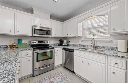 National Hills House | 3 bedroom, 2.5 bathroom patio home with an inground pool. The sleeping arrangements at this property include three queen beds and a futon located in the second living room.