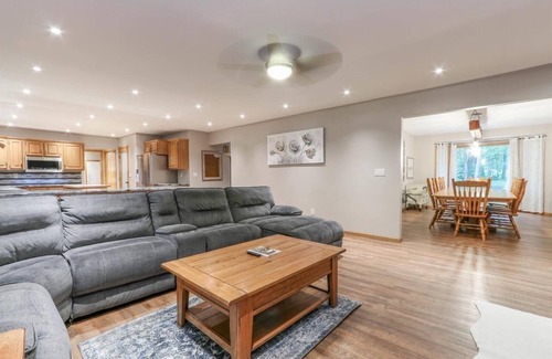 Waupaca House | A beautiful recently remodeled home nested on a wooded river lot with a hot tub.