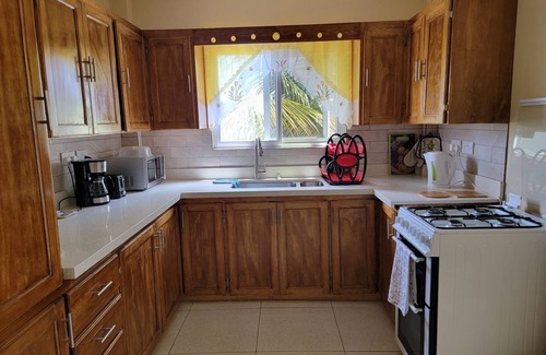 Crochu Apartment | Charming 2-bedroom hideaway near Cabier, full kitchen and air-conditioned rooms.