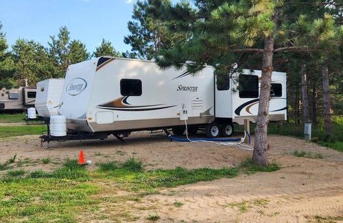 Nevis RV Rental | Deluxe Camper at a RV park