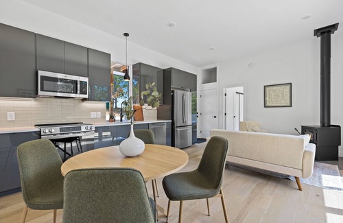 Young Harris Apartment | Escape to a 2BR/1BA tiny home in the North Georgia mountains. Create meals in the chef’s kitchen, cozy up by the wood-burning stove, refresh in the spa-style shower, and enjoy crisp mountain air and brilliant fall colors from your private deck.