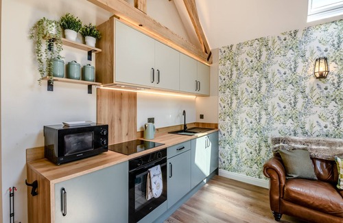 Arnold Cottage | Exposed beams and calming green colours for this holiday home.