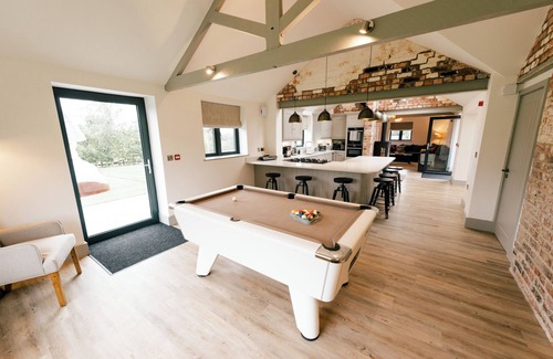 Nantwich House | Imagine relaxing on a spacious corner sofa, wrapped in the warmth of your loved ones, as the gentle crackle of a log burner fills the room. Picture yourself unwinding in a hot tub at sunset, drink in hand, with the stresses of the week melting away.