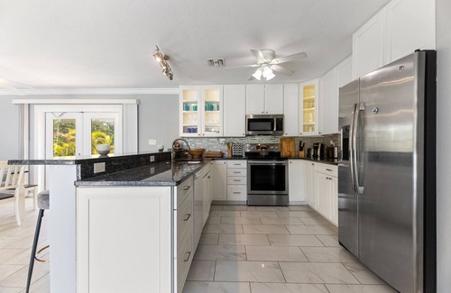 Bay Point House | Key West Beach House with heated pool, tiki, and dock.♿︎