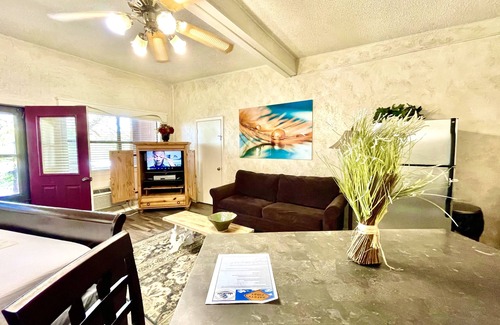 Mount Ida Apartment | King Studio with king bed, dining area, sleeper sofa and view of Lake Ouachita by RedAwning