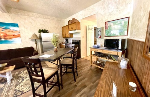 Mount Ida Apartment | King Studio with king bed, dining area, sleeper sofa and view of Lake Ouachita by RedAwning