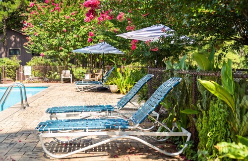 Mount Ida Cottage | Lake view two bedroom, two bath loft, log-sided cottage with private hot tub overlooking Lake Ouachita. by RedAwning