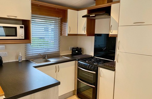 Hamworthy House | Lotus 2 bedroom dog friendly caravan with veranda offers a stunning sea view.