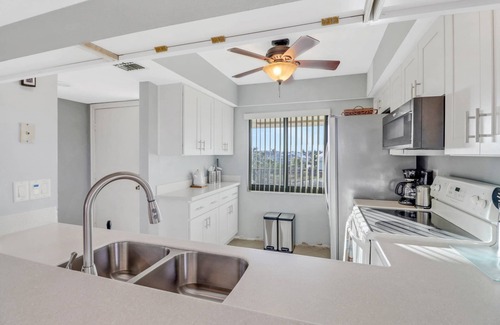 Mid Island Condo | Lovely End-Unit, Lagoon-Front Community, South of Mid-Island! Heated Community Pool! Free Parking!