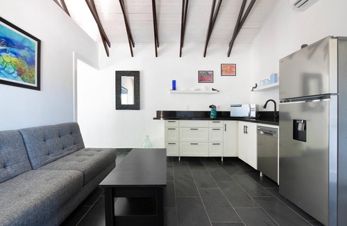 Roatan Cottage | Modern Beachfront Home - Steps from the Sea w/Patio, Shared Pool & Dock