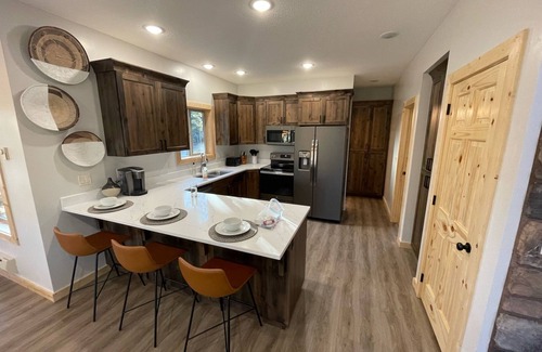 Duck Creek Village Cabin | Modern Cabin w/Hot Tub, Swings, Fire Pit, & Kayaks