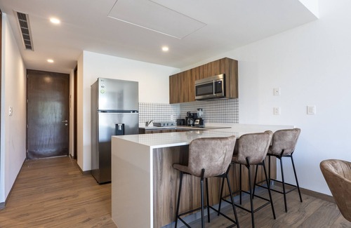 Playacar Condo | Modern, family-friendly condo with pool view, full kitchen & WiFi