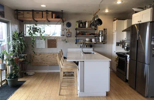 Ennis House | Pet friendly home with fenced yard, gardens and sauna one block from Main Street