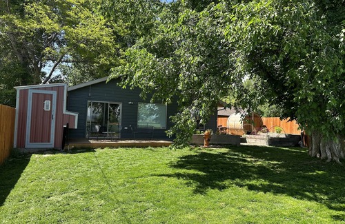 Ennis House | Pet friendly home with fenced yard, gardens and sauna one block from Main Street