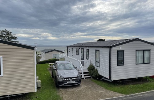Hamworthy House | Rambling Rose caravan with sea view on Rockley Park