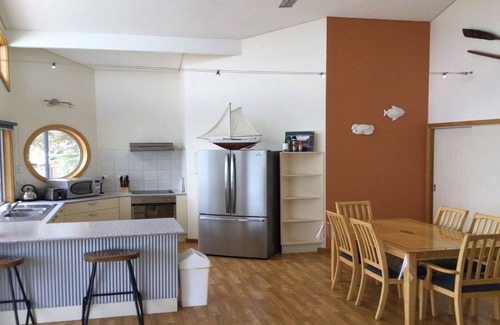 Lake Wangary House | Rest A Shore is a waterfront property with spacious living and north facing panoramic view over the bay from the front deck.