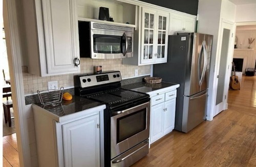 Menasha House | Riverfront Oasis - Hot tub- Seasonal heated pool