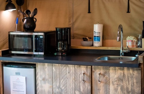 Mill Spring House | Safari Tent nestled in the woods, creek side, furnished balcony, pet friendly, sleeps 5.