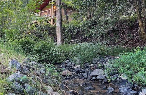 Mill Spring House | Safari Tent nestled in the woods, creek side, furnished balcony, pet friendly, sleeps 5.