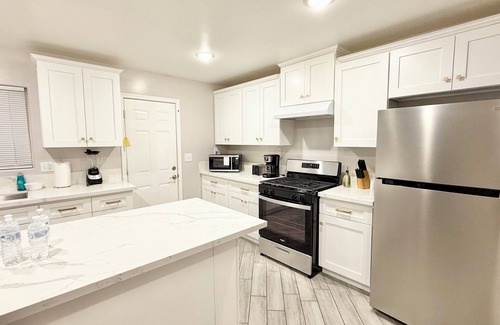 Baker Street House | Spacious 4-bedroom house in charming Bakersfield with AC. 4 queen & 3 twin beds.