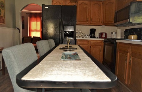 Grand Forks House | The Bungalow: inviting retreat with a spacious backyard sets for BBQs.