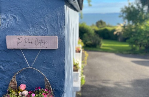 Carrickfergus Cottage | The Pink Cottage Upstairs Suite and Secret Garden. beautiful walks & sea view.