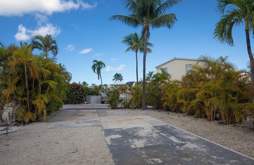Cudjoe Key RV Rental | Tropical RV Lot Oasis in the Florida Keys with Paved Patio, Full Hookups & Palm-Tree Privacy
