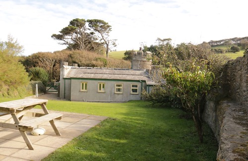 Caerhays Cottage | Turreted gatehouse to the historic Caerhays Castle located on the beach on the south Cornish Coast