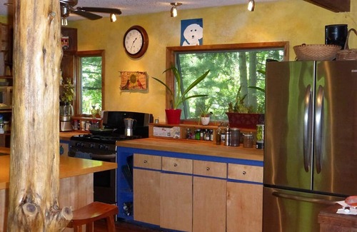 Three Oaks House | You're in a hot tub; you see gardens and hear wind blowing through the pines.