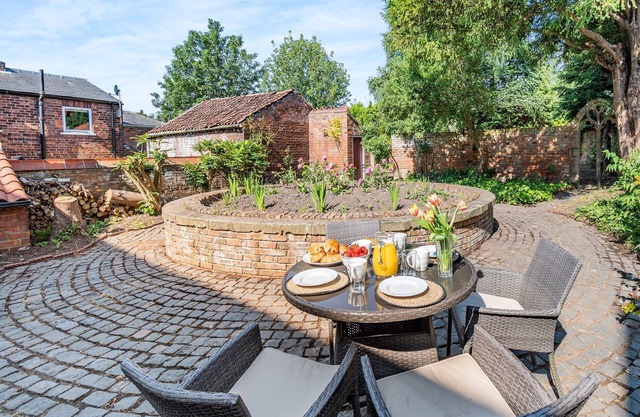 A charming, thoughtfully renovated cottage within the 17th century Papist Hall.