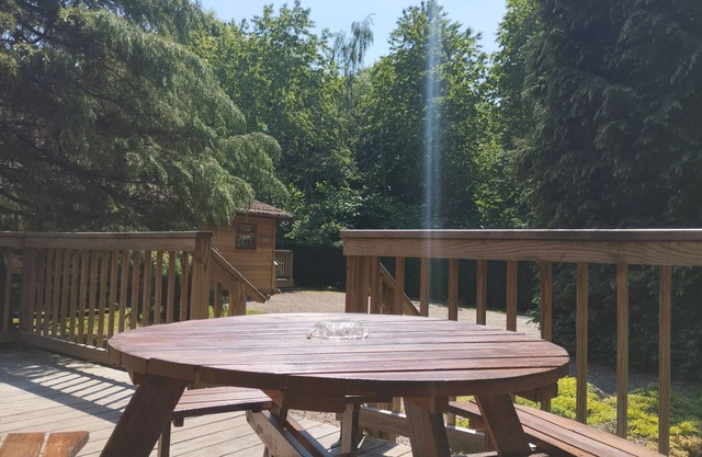 A charming & traditional Scandinavian log cabin within a tranquil setting.