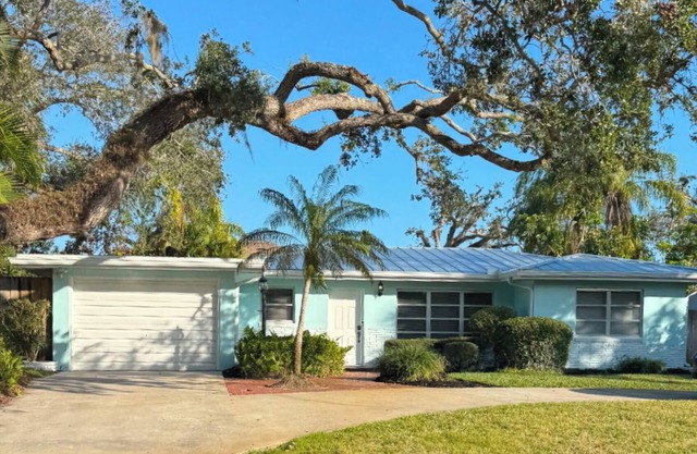 A tropical retro bungalow secluded area with terrazzo flooring & heated pool.