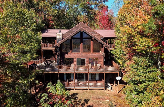 Antler Ridge - a stunning log cabin with spacious deck equipped with outdoor fireplace, hot tub, and scenic mountain views!