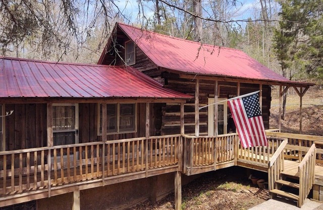 Authentic log cabin nestled in the woods by creek