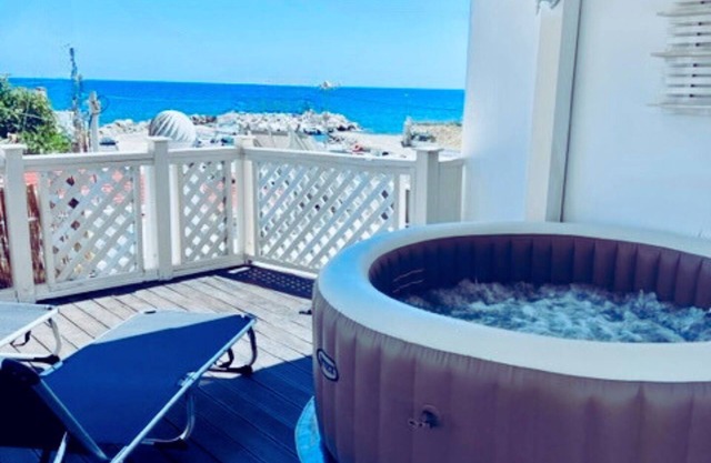 Beach front Villa with hot tub, just steps from the sea