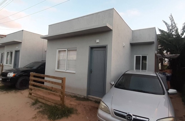 Beach house in front of green area