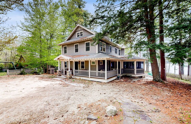 Captivating waterfront home with private dock & beach, lake views