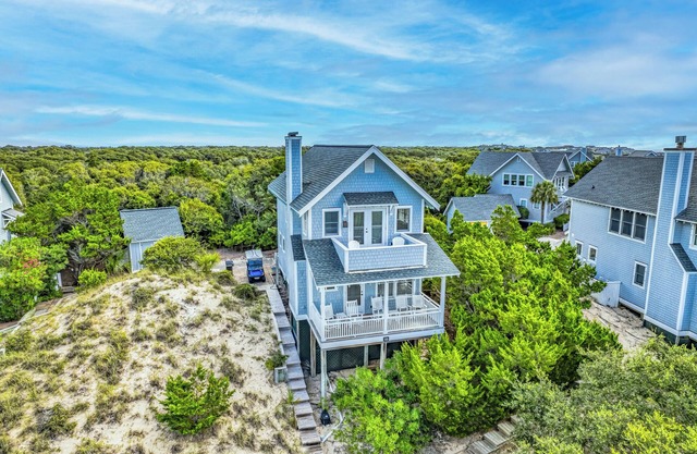 Charming cottage nestled high on the dune ridge w/both clubs!