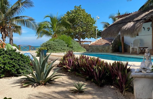 Charming single level beachfront home! Garden oasis & private waterfall pool.