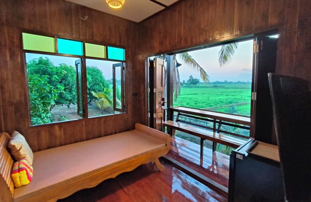Charming Thai-style villa in lush greenery 10 mins from bus station near city.