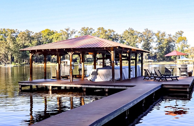 Colorful lakefront home with private dock, scenic porch, washer/dryer, & AC
