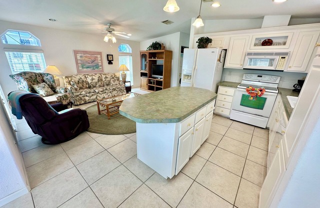 Come enjoy paradise in this awesome beach house with large open kitchen, dining and living area.