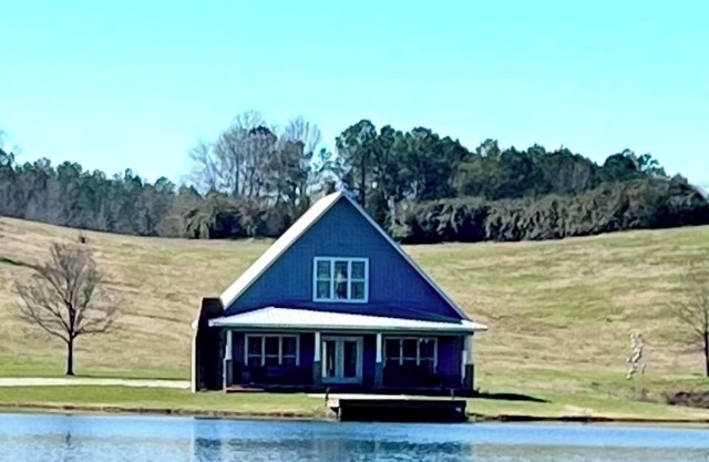 Cottage nestled on 75 acres with beautiful views and 14 acre stocked lake.