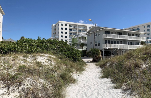 Cottage on the beach! 30 second walk away! Heated pool on the property!