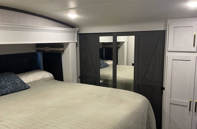 Deluxe 5th wheel in beautiful forest setting ready for you.