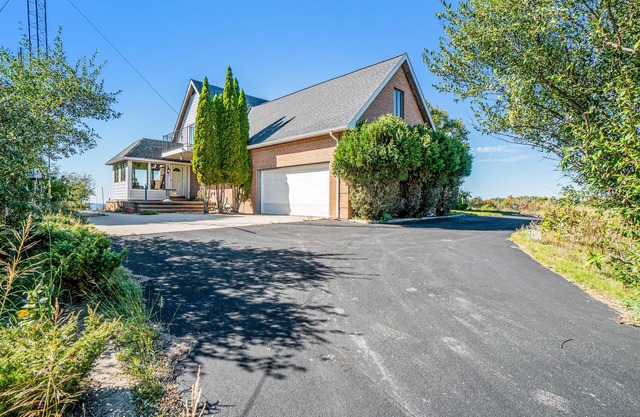 Dog-friendly, lake view home with three season room, fireplace, video projector