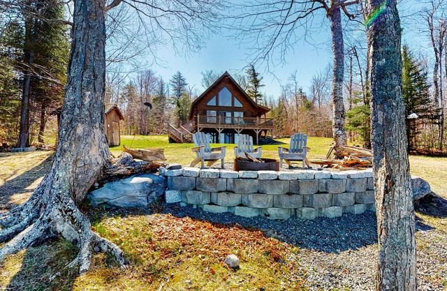 Dog-friendly lakefront cabin with covered porch & firepit on the shore
